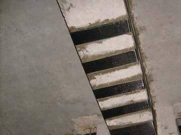 Carbon fiber reinforcement of floor cracks in basement